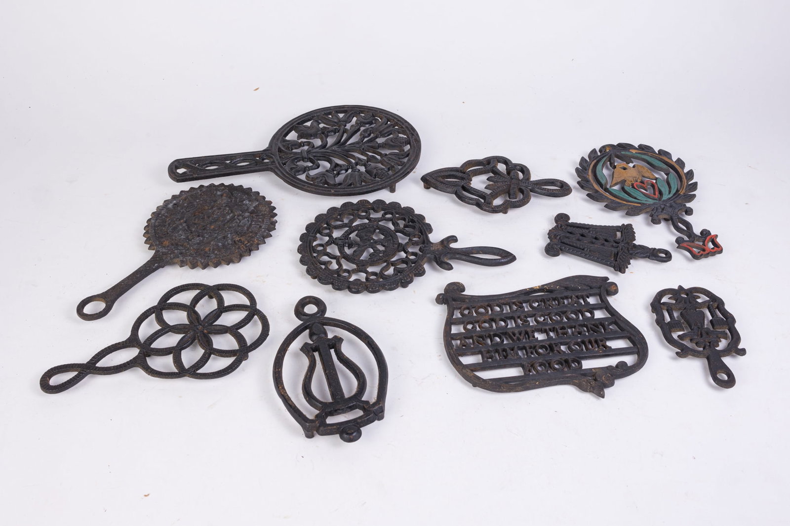 Vintage and Antique Cast Iron Ornate Trivets: Vintage and Antique Cast Iron Ornate Trivets Size 7" x 12" x 12" (box size, three boxes) Literature Brooks Auction is not responsible for outbids. Questions? Call the office at (856) 694-2960 or ema