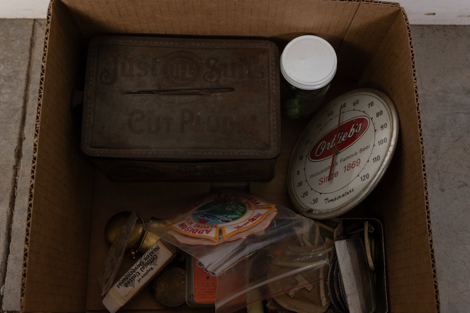Assortment Lot: Assortment Lot: vintage advertising tobacco tin - Ortlieb's advertising thermometer - marbles - assorted patches - compasses - pins - and more
