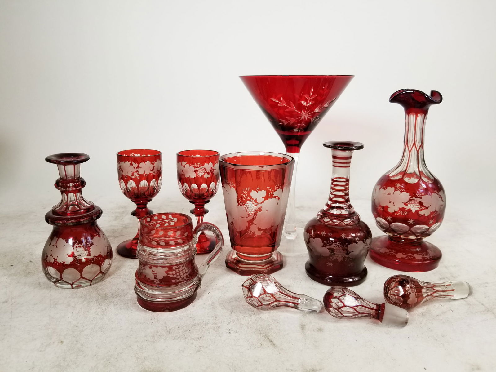 Antique Ruby Bohemian Cut To Clear Glassware: Antique Ruby Bohemian Cut To Clear Glassware Size 7" x 12" x 12" Literature Brooks Auction is not responsible for outbids. Questions? Call the office at (856) 694-2960 or email us directly at info@b