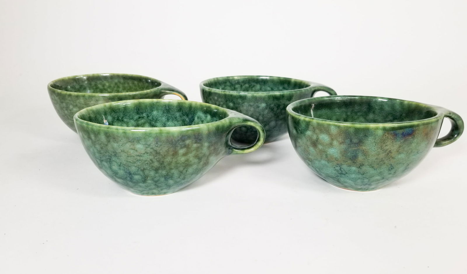 Four Roseville Raymor by Ben Seibel Frogskin Tea Cups: Four Roseville Raymor by Ben Seibel Frogskin Tea Cups Size 7" x 12" x 12" Literature Brooks Auction is not responsible for outbids. Questions? Call the office at (856) 694-2960 or email us directly