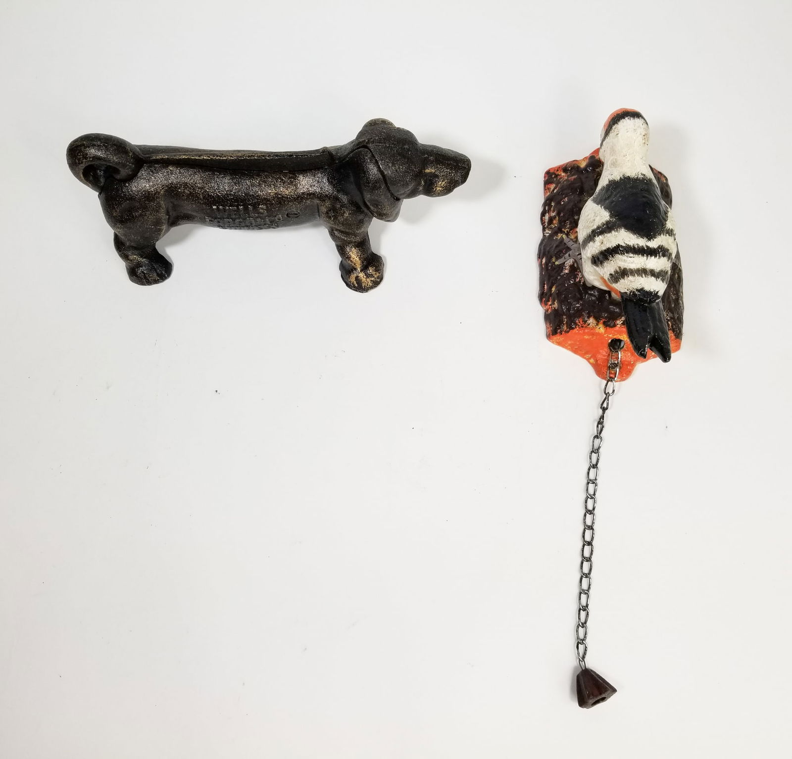 Two Cast Iron Figures: Two Cast Iron Figures: cast iron dachshund shoe scraper - cast iron woodpecker door knocker Size 5" H Literature Brooks Auction is not responsible for outbids. Questions? Call the office at (856) 69