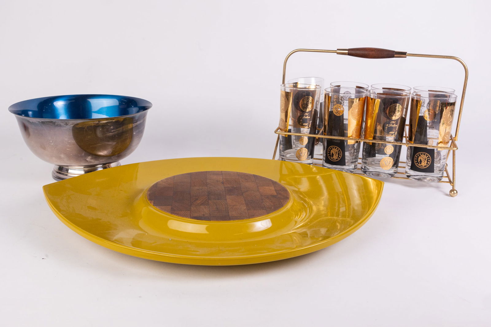 Mid Century Modern Decor Lot: Mid Century Modern Decor Lot: Cera gold coin set of eight glasses with carrier - Wallace Color Clad decorative bowl - MCM leaf shaped decorative tray Literature Brooks Auction is not responsible for
