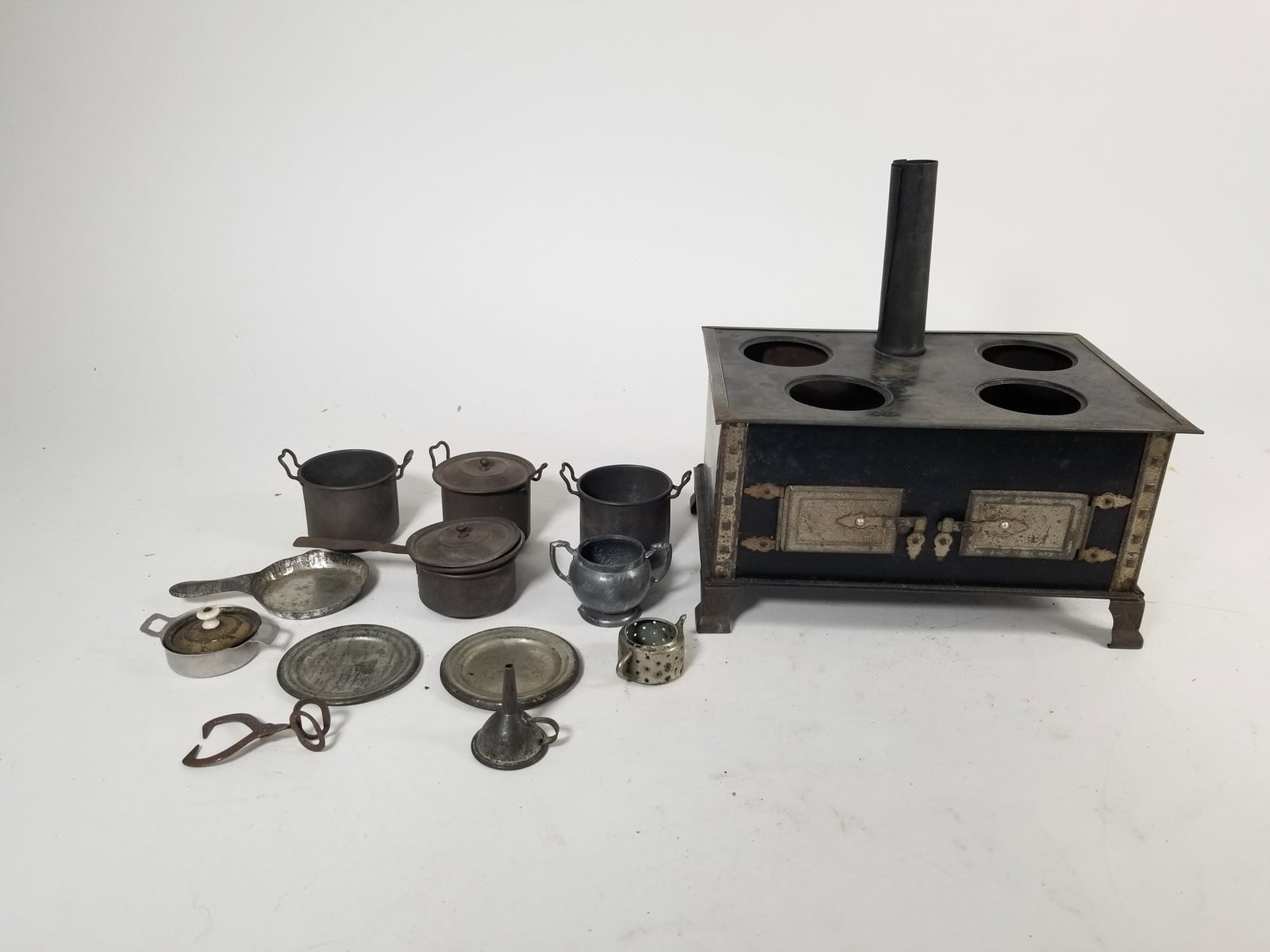 Antique German Tin Miniature Oven & Cookware: Antique German Tin Miniature Oven & Cookware Size 5" x 8" x 6" Literature Brooks Auction is not responsible for outbids. Questions? Call the office at (856) 694-2960 or email us directly at info@bro