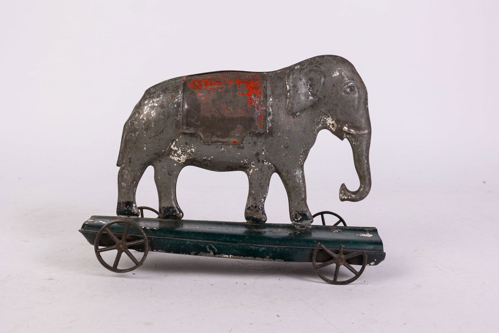 Early American Tin Elephant on Wheels Pull Toy: Early American Tin Elephant on Wheels Pull Toy Size 6" x 9" x 3" Literature Brooks Auction is not responsible for outbids. Questions? Call the office at (856) 694-2960 or email us directly at info@b