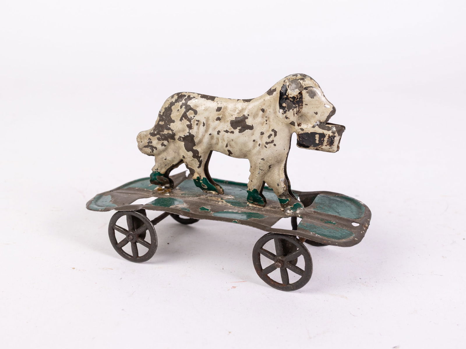 1880s American Tin Toy Dog with Basket on Wheels: 1880s American Tin Toy Dog with Basket on Wheels Size 4" x 5" x 2" Literature Brooks Auction is not responsible for outbids. Questions? Call the office at (856) 694-2960 or email us directly at info
