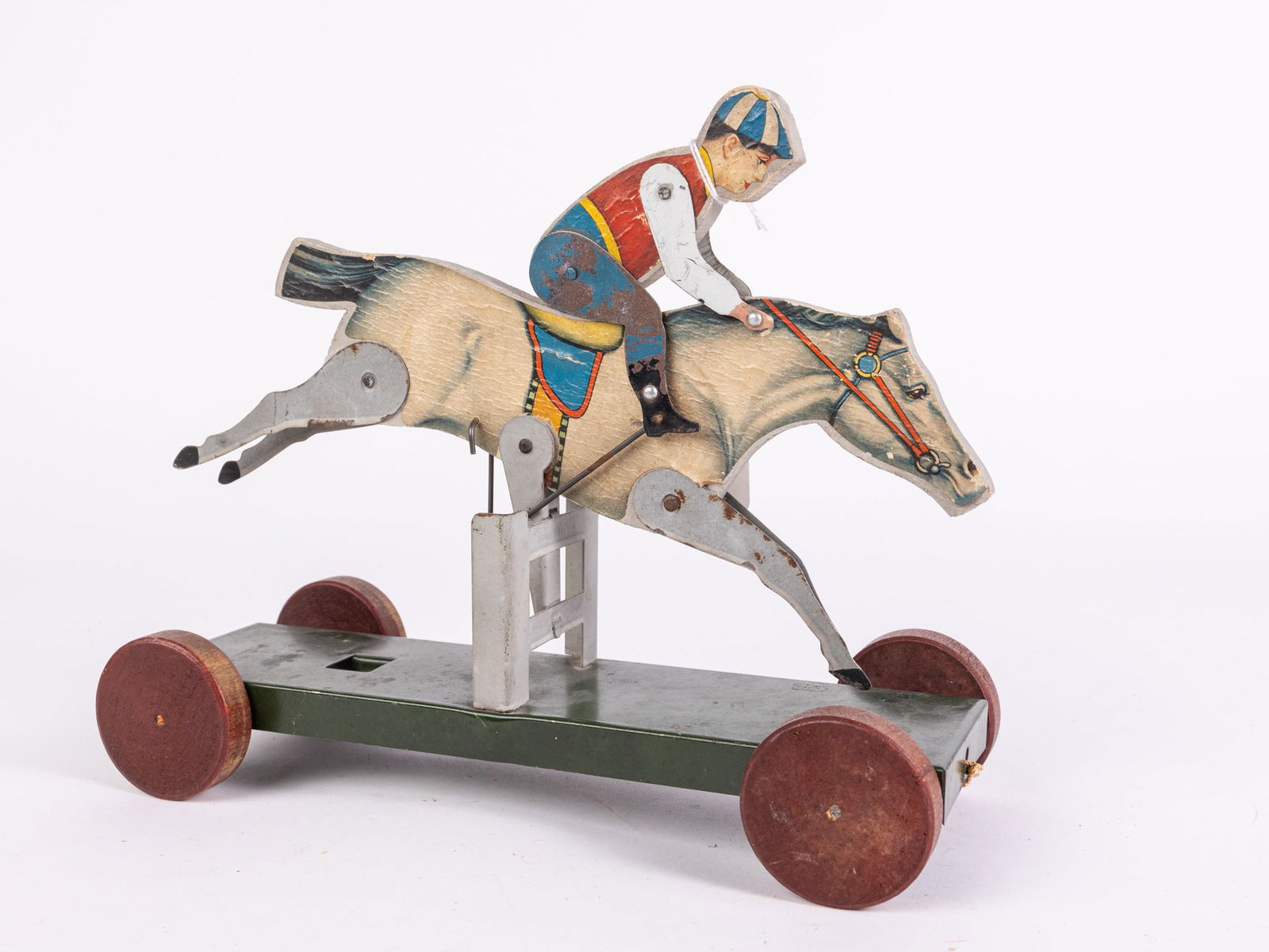 c. 1926 Early Gibbs Hurdle Rider #39 Pull Toy: c. 1926 Early Gibbs Hurdle Rider #39 Pull Toy Size 9" x 10" x 4" Literature Brooks Auction is not responsible for outbids. Questions? Call the office at (856) 694-2960 or email us directly at info@b