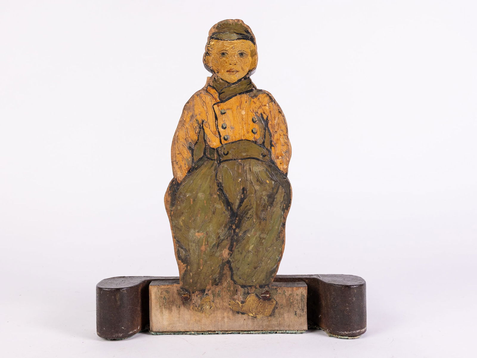 Antique Folk Art Wood and Iron doorstop: Antique Folk Art Wood and Iron doorstop, painted wooden cut out of a young boy attached to cast iron base. likely early 20th century Size 12" x 10" x 3" Literature Brooks Auction is not responsible f