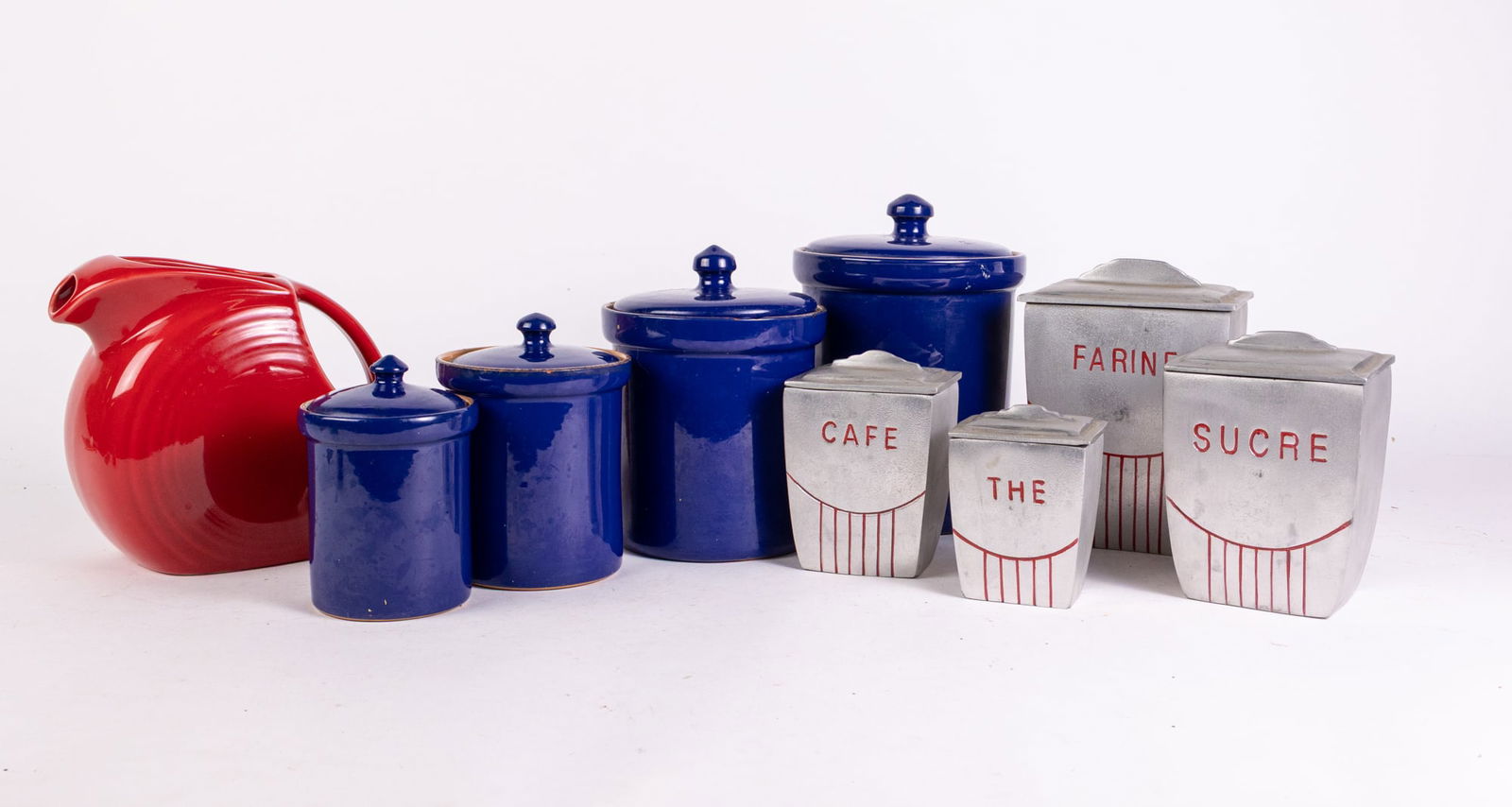 Lot of Vintage and Retro Kitchen Accessories: Lot of Vintage and Retro Kitchen Accessories: art deco style retro Anthropologie canisters set of four - ceramic cobalt blue set of four kitchen canisters - Fiestaware ceramic pitcher Literature Broo