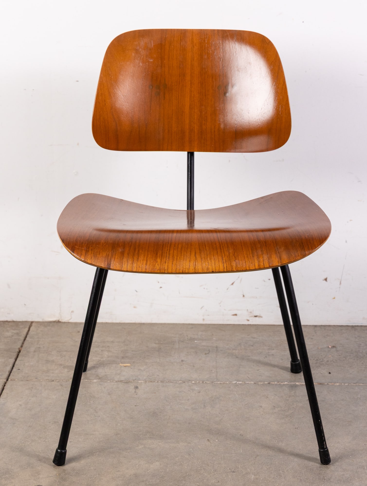 Charles & Ray Eames | Herman Miller "DCM" Dining Chair: The Herman Miller "DCM" (Dining Chair Metal), designed by Charles and Ray Eames in 1946, is a timeless icon of mid-century modern design. Featuring molded plywood seat and back panels with a sleek, ch