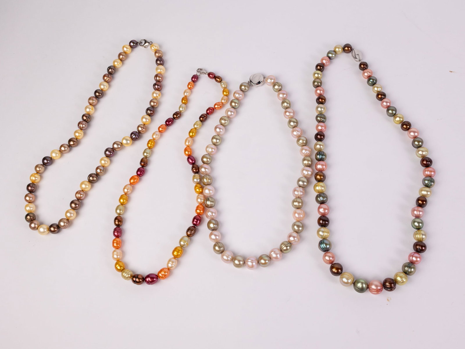 Four Chinese Freshwater Pearl Necklaces: (4) Chinese Freshwater Pearl Necklaces: According to the Attached Estate Appraisal: Four stamped 925 silver lady's necklaces. Condition is very good. The four strands of Chinese Freshwater pearls meas