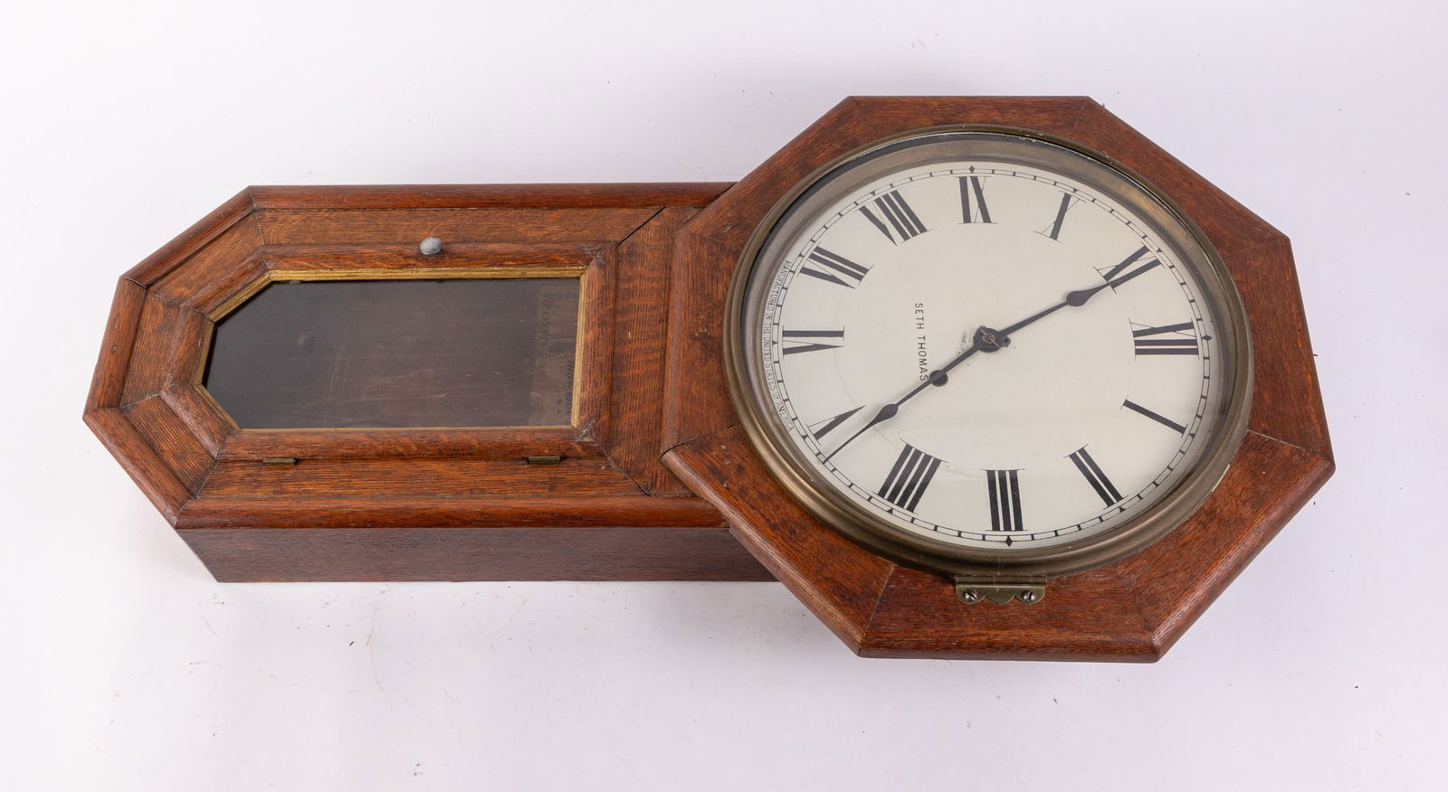 Seth Thomas Antique Wall Mounted Clock: Seth Thomas Antique Wall Mounted Clock, Antique wall mounted clock in oak case by Seth Thomas. Weighted brass pendulum. Unknown if functions, but cosmetically good condition. Some damage to interior l