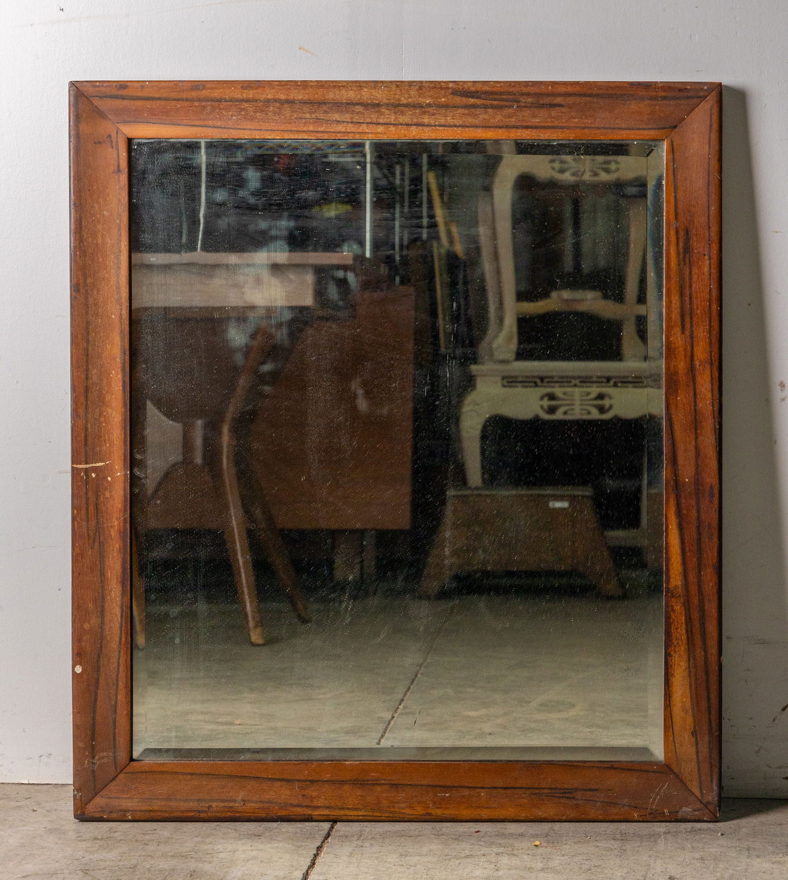 Antique Wood Framed Rectangular Mirror: Antique Wood Framed Rectangular Mirror, Wall mounted rectangular antique mirror with bevelled edge and wood frame. Mirror is incredibly heavy, shows signs of use and wear typical with age. Size 33" x
