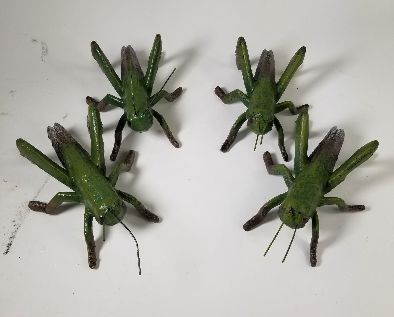 Set of Four Cast Iron Grasshoppers: Set of Four Cast Iron Grasshoppers Size 7" x 12" x 12" Literature Brooks Auction – Online Auction Terms & Conditions ———————————