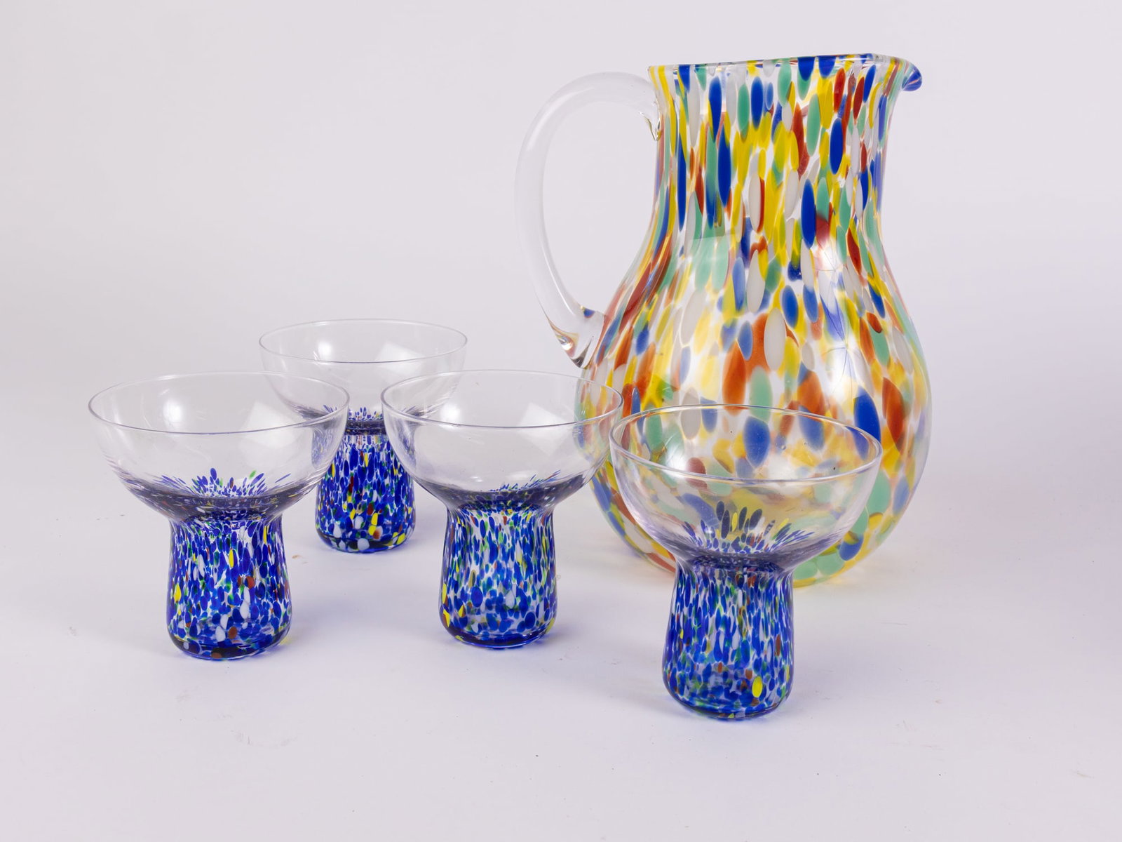 Hand Blown Murano Style Margarita Set: Hand Blown Murano Style Margarita Set: the pitcher has a crack near the handle Size 7" x 12" x 12" Literature Brooks Auction – Online Auction Terms & Conditions ————̵