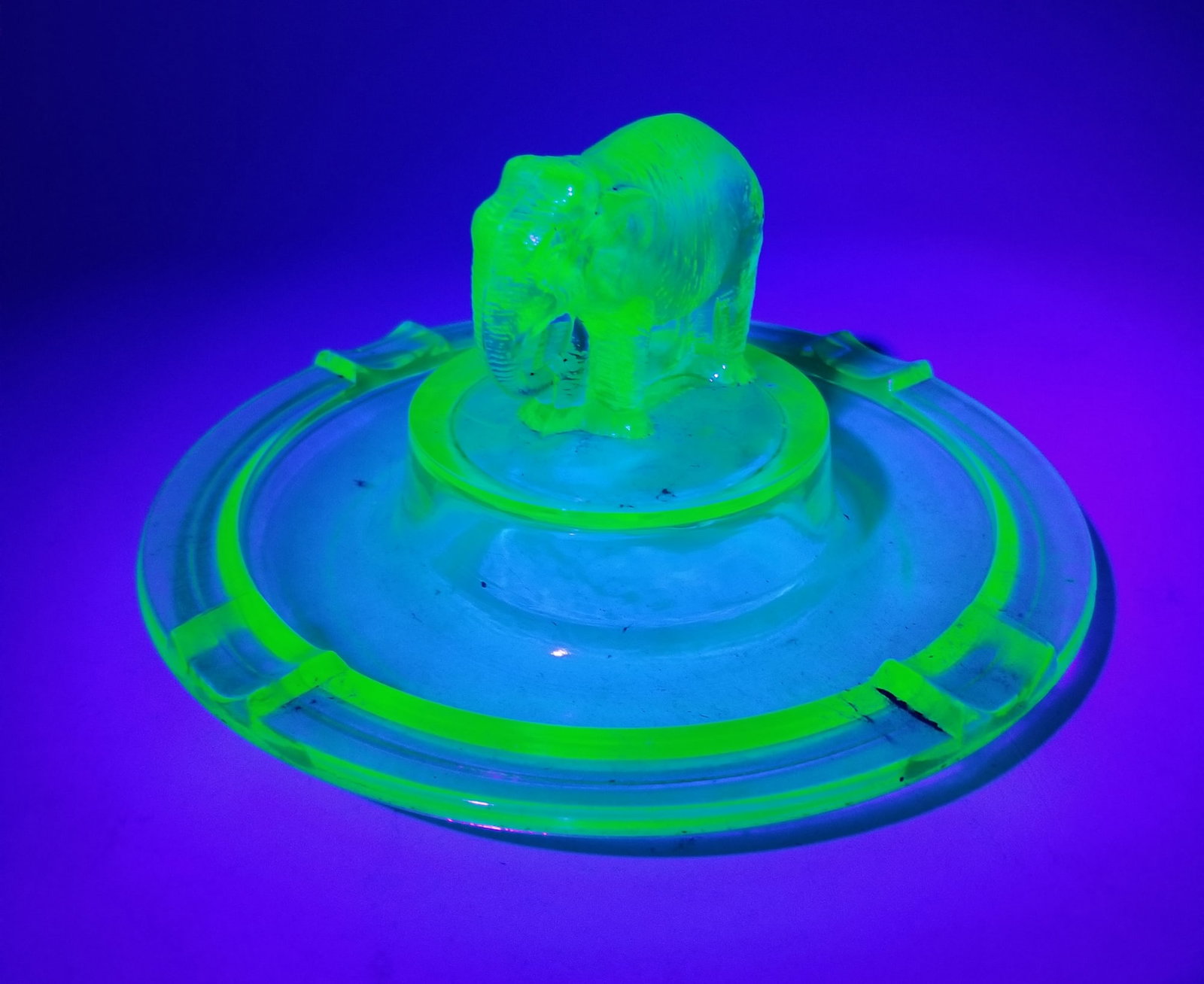 Vintage Uranium Glass Elephant Figural Ashtray: Vintage Uranium Glass Elephant Figural Ashtray Literature Brooks Auction is not responsible for outbids. Questions? Call the office at (856) 694-2960 or email us directly at info@brooks.auction. ̶