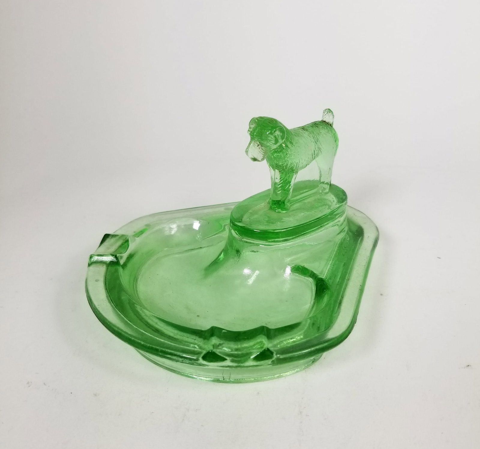 Vintage Uranium Glass Terrier Dog Figural Ashtray: Vintage Uranium Glass Terrier Dog Figural Ashtray Size 3" x 5" x 6" Literature Brooks Auction is not responsible for outbids. Questions? Call the office at (856) 694-2960 or email us directly at inf