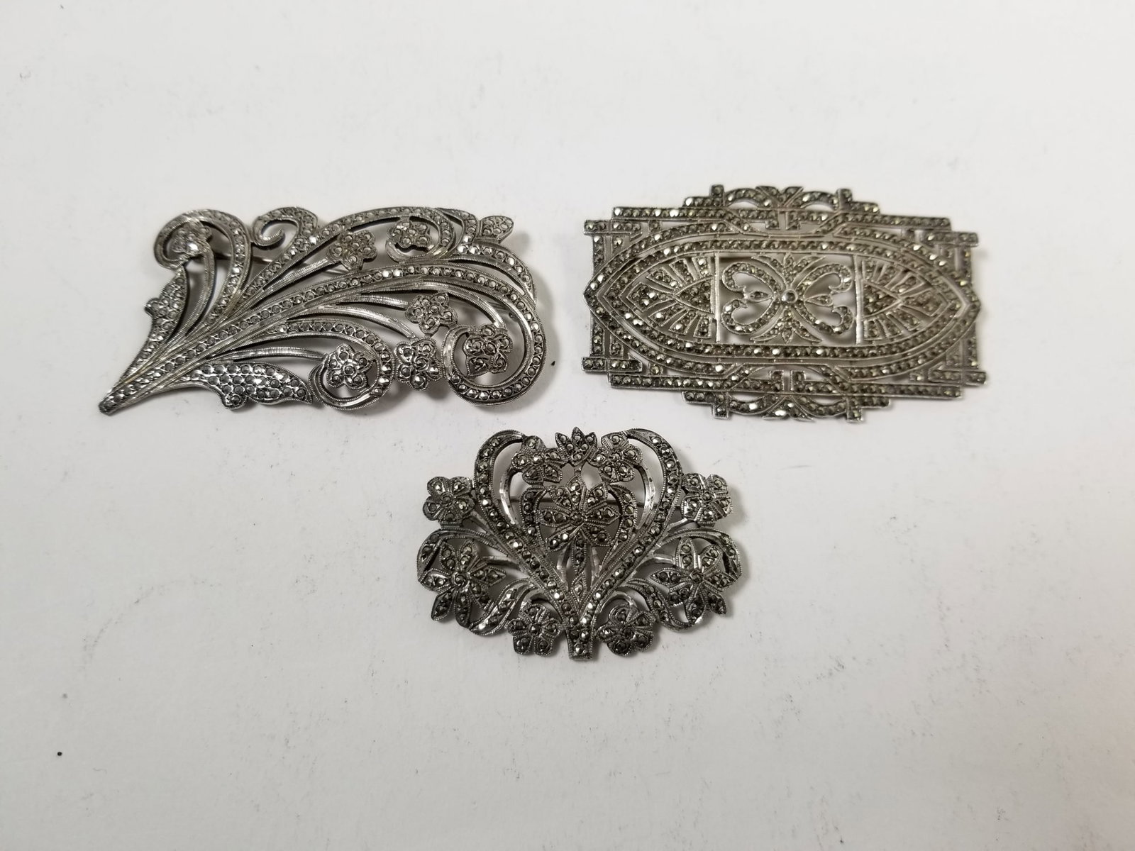 Three Vintage Sterling Silver Art Deco Brooches: (3) Vintage Sterling Silver Art Deco Brooches, all marked sterling, total weight 37.4 grams Literature Brooks Auction – Online Auction Terms & Conditions —————̵