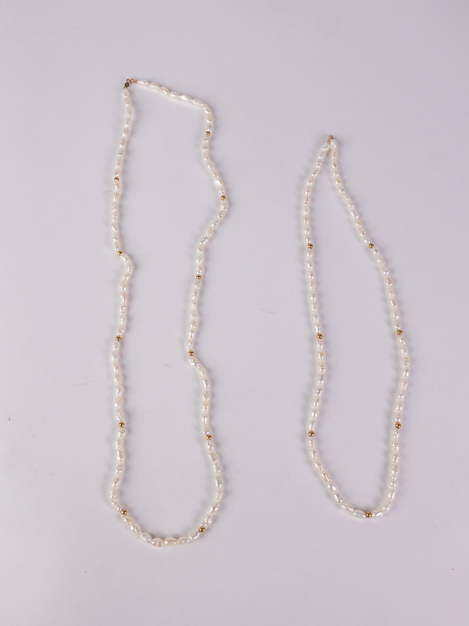 Pair of Uncultured Pearl 14KY Gold Clasp Necklaces: Pair of Uncultured Pearl 14KY Gold Clasp Necklaces, marked 14K, untested Literature Brooks Auction – Online Auction Terms & Conditions ————————
