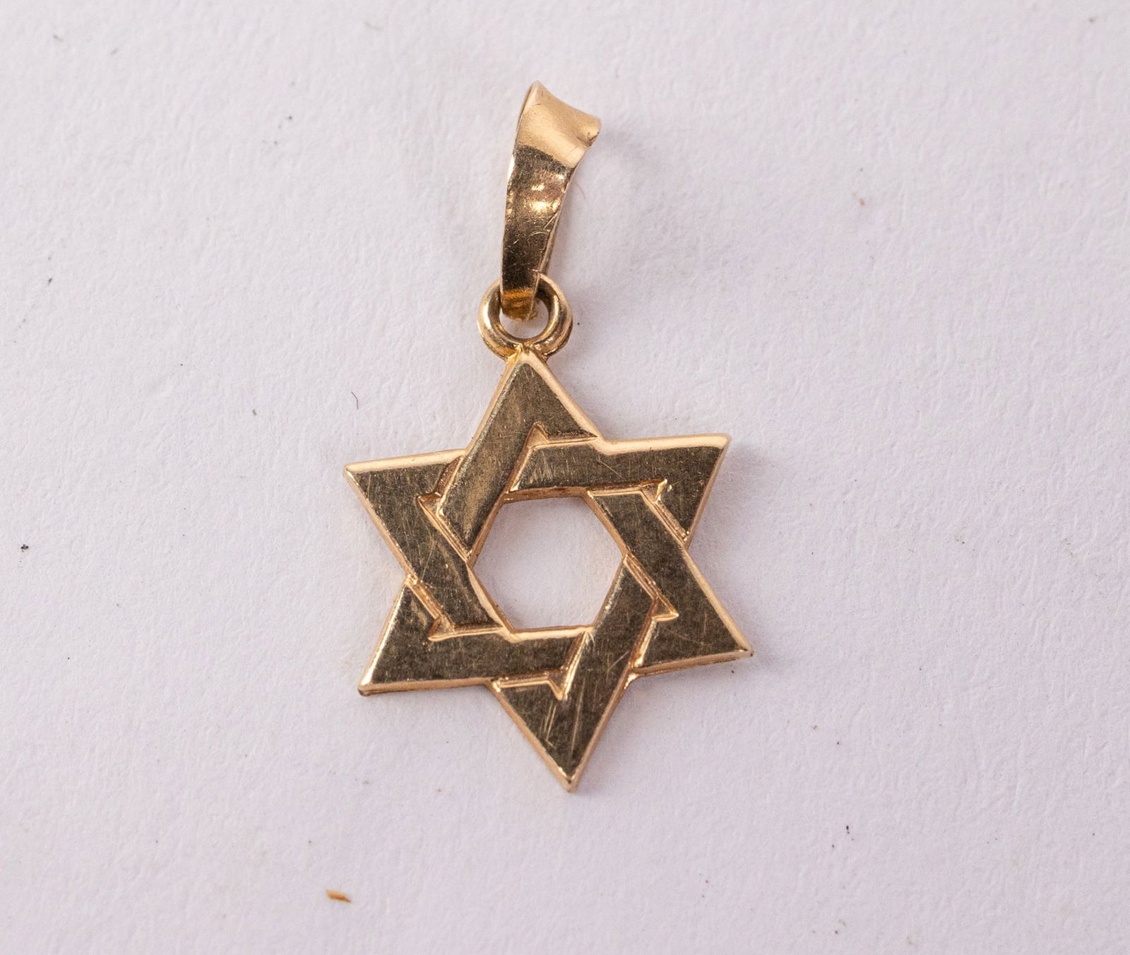 14KY Gold Star of David Pendant: 14KY Gold Star of David Pendant, marked 14K, untested, total weight 0.6 grams Literature Brooks Auction – Online Auction Terms & Conditions ———————̵