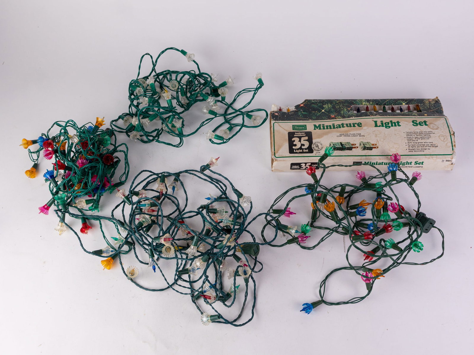 Lot of Assorted Vintage Christmas Lights: Lot of Assorted Vintage Christmas Lights, tested and only one strand (one of the rainbow flower lights) is working, others are not. Size 7" x 12" x 12" Literature Brooks Auction – Online Auction