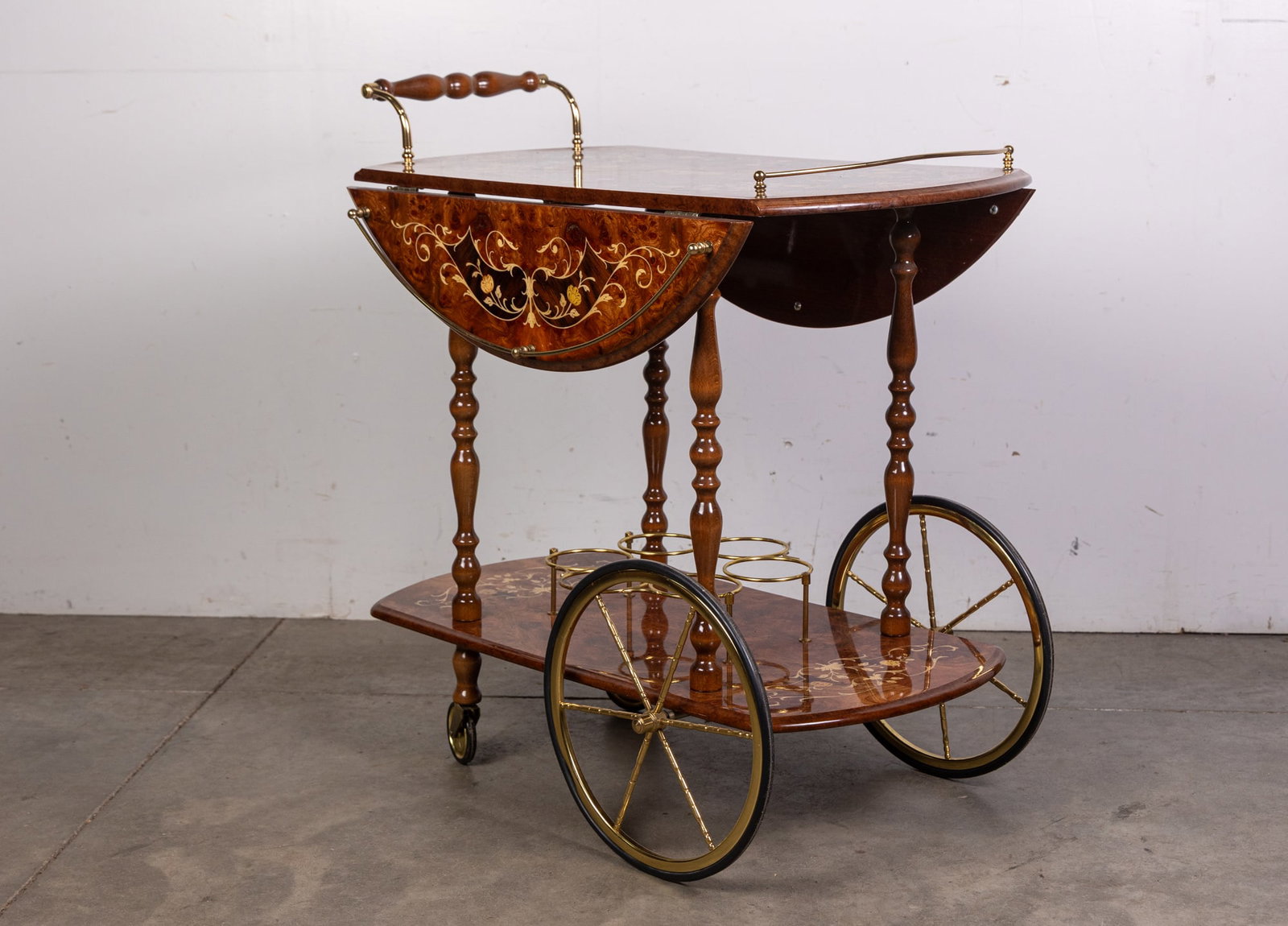 Italian Marquetry Bar/Tea Cart: Marked "Made in Italy" this bar cart features sophisticated inlaid wood and brass hardware accents Size 31" x 26" x 16" Literature BROOKS AUCTION WILL RE-OPEN JANUARY 5TH FOR PREVIEW All Inquiries