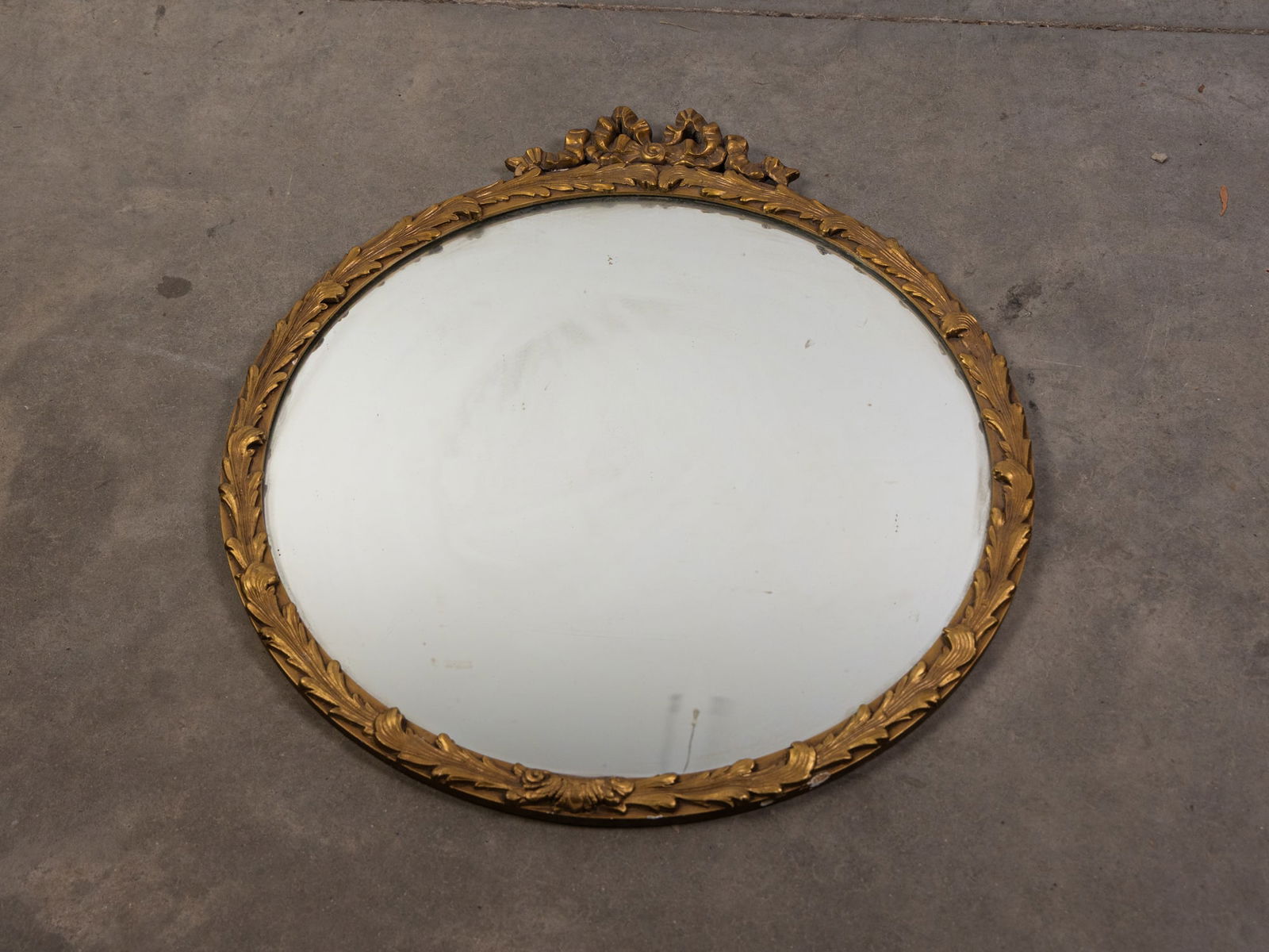 Antique Giltwood Mirror: Ribbon & Foliate Adorned Size 29" x 26" Literature BROOKS AUCTION WILL RE-OPEN JANUARY 5TH FOR PREVIEW All Inquiries will be adressed when we returnQuestions? Call the office at (856) 694-2960 or e