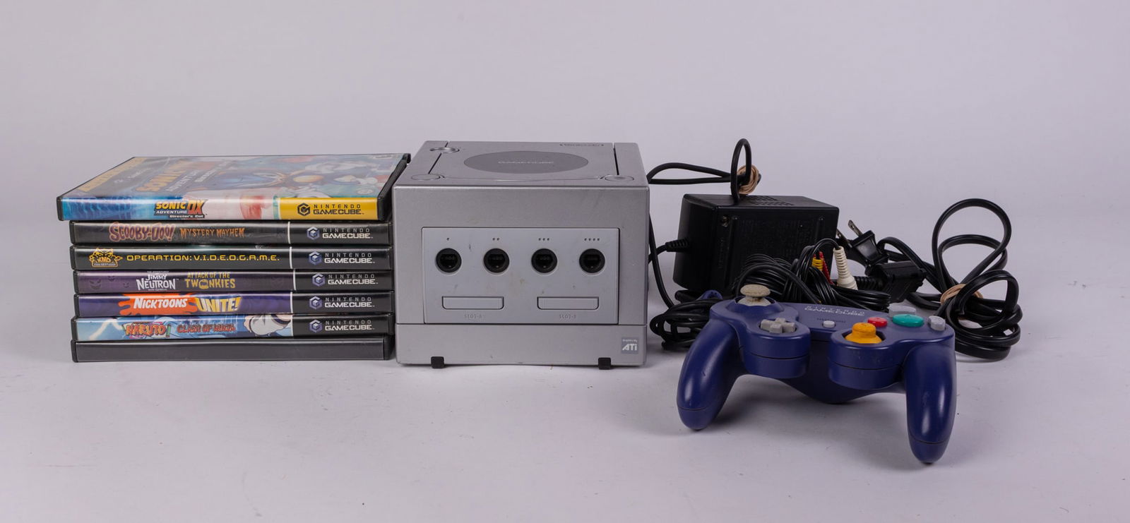 Silver Nintendo GameCube with Games and Accessories: Silver Nintendo GameCube with Games and Accessories, Includes console, controller, AV cord, AC adapter, and assorted games. Tested and powers on but has trouble reading game disc. Literature Brooks Au