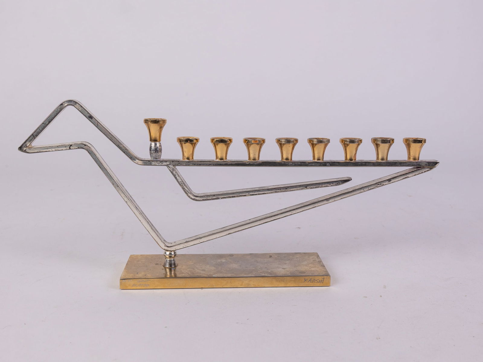 H. Karshi Judaica 24k Gold Plated Modern Menorah Sculpture: H. Karshi Judaica 24k Gold Plated Modern Menorah Sculpture: signed and marked on the baseSize5" x 12" x 2"Literature Brooks Auction is not responsible for outbids. Questions? Call the office at