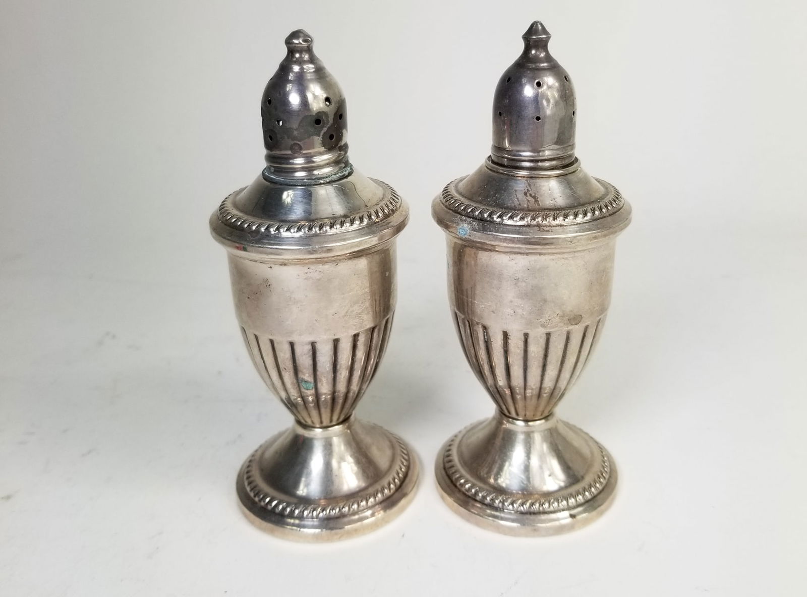 Pair of Sterling Silver Weighted Shakers: Pair of Sterling Silver Weighted Shakers, marked sterling weighted, total weight 288.9 grams Size 5" Literature Brooks Auction is not responsible for outbids. Questions? Call the office at (856) 694