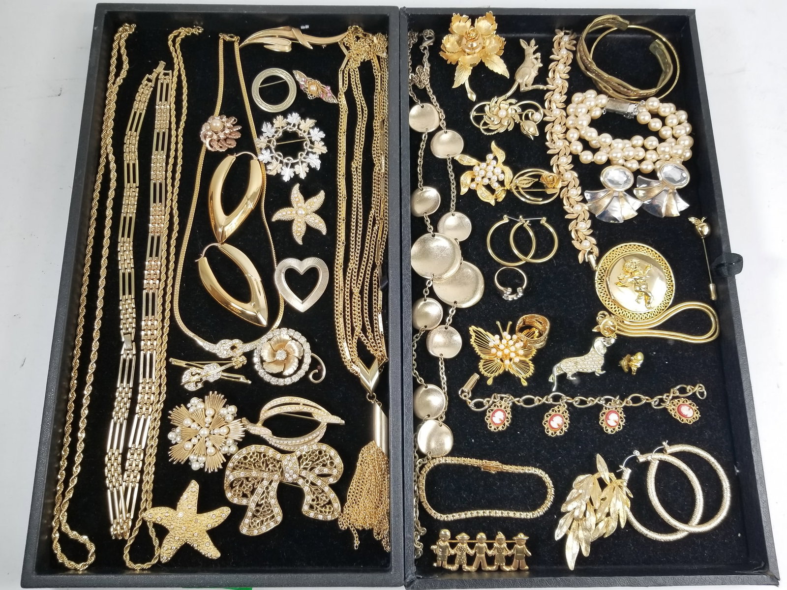 Collection of Gold Tone Statement Jewelry: Collection of Gold Tone Statement Jewelry, includes an assortment of vintage and contemporary jewelry. Featuring a Warner flower brooch, Trifari pearled starburst brooch, and Sarah Cov multi tone