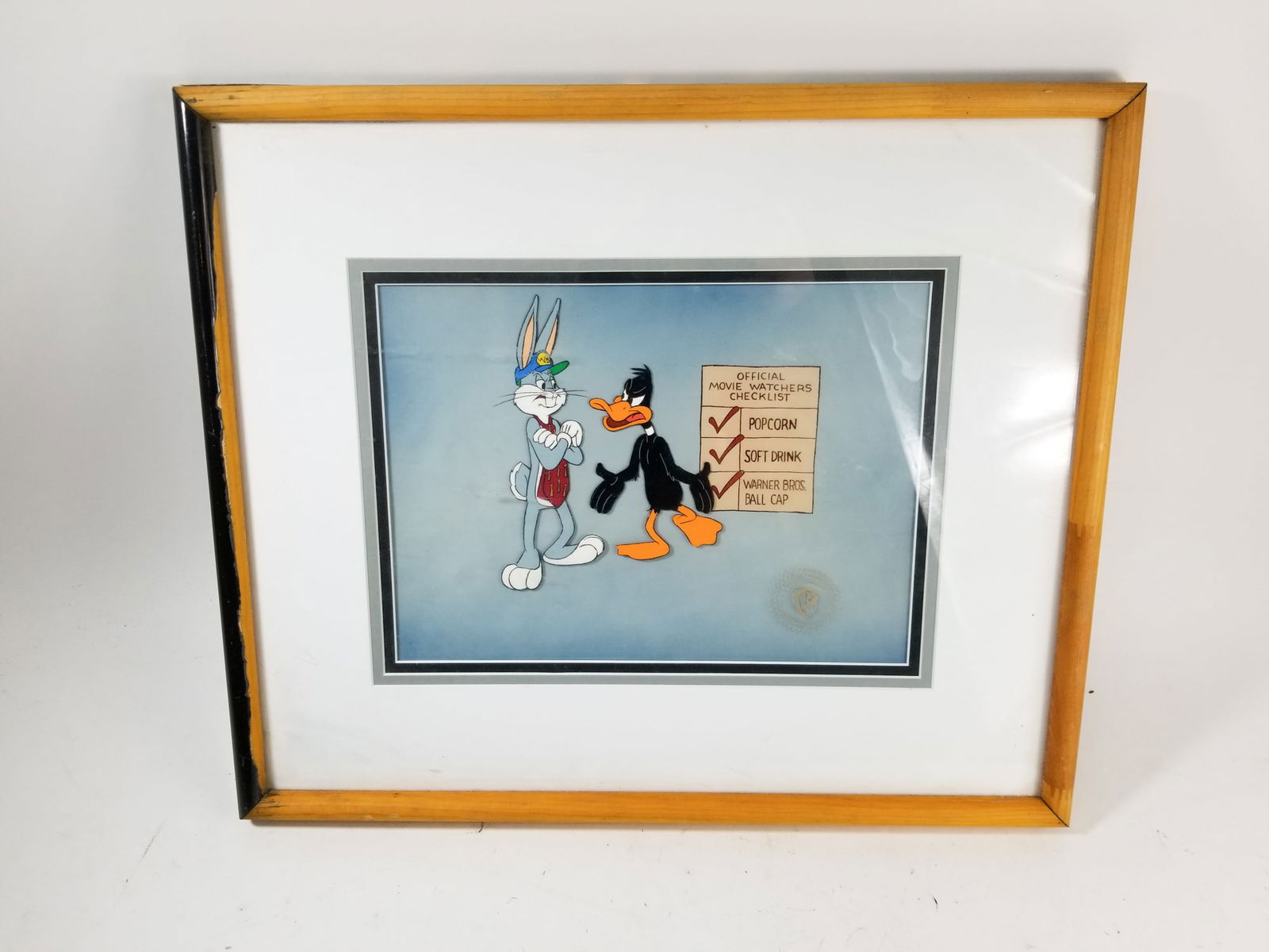 Warner Brother Bugs Bunny Commercial Production Framed Cel: Warner Brother Bugs Bunny Commercial Production Framed Cel, From the 1988 Warner Bros. Home Video Commercial "Watch This Movie" starring Daffy Duck. Includes COA on back.Size16" x 19"LiteratureBrooks