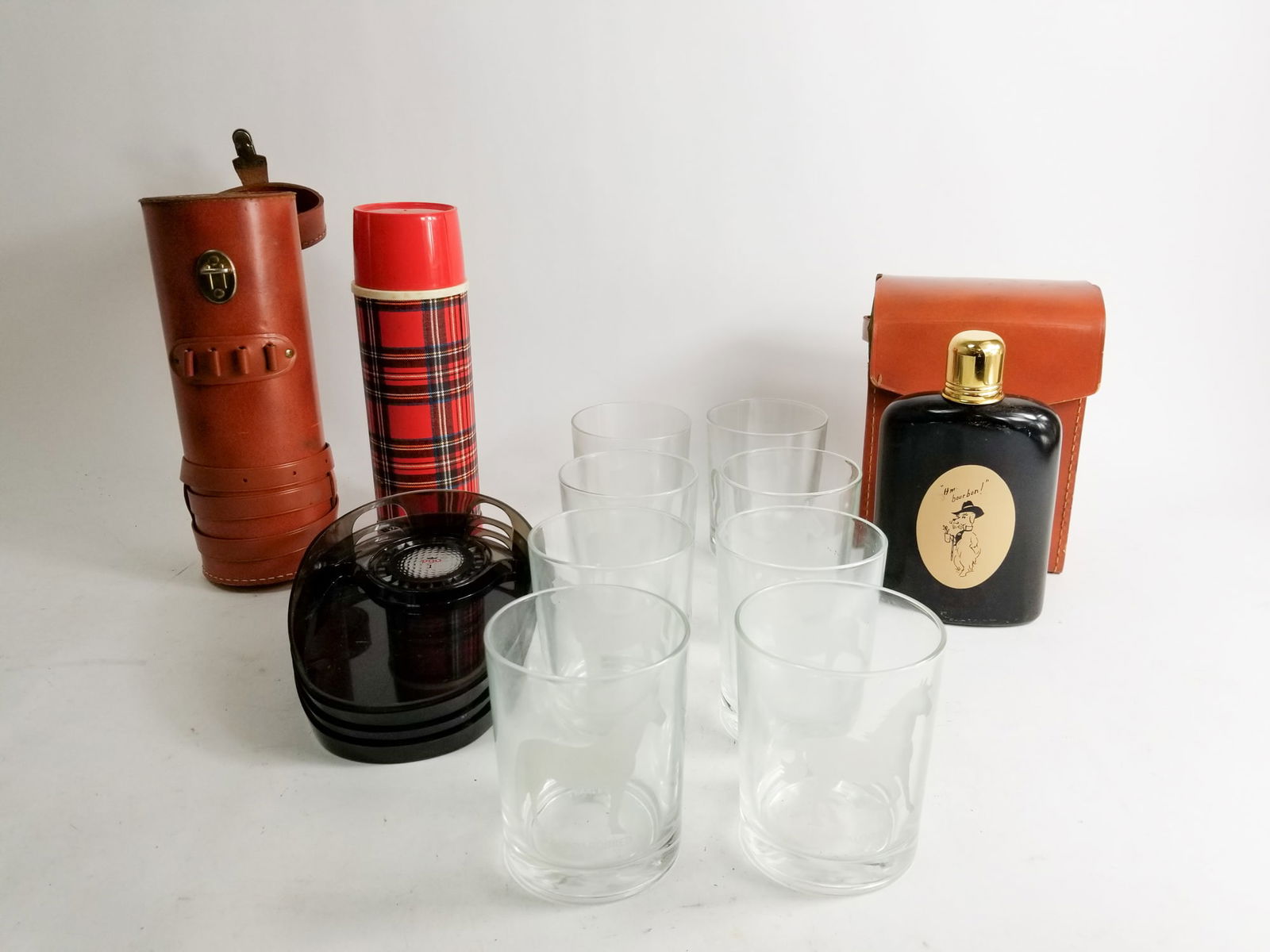 Man Cave Assortment Lot: Man Cave Assortment Lot: horse tumbler glasses - plaid vintage thermos - vintage office golf putt putt cups - and more Size 7" x 12" x 12" Literature Brooks Auction – Online Auction Terms & Cond