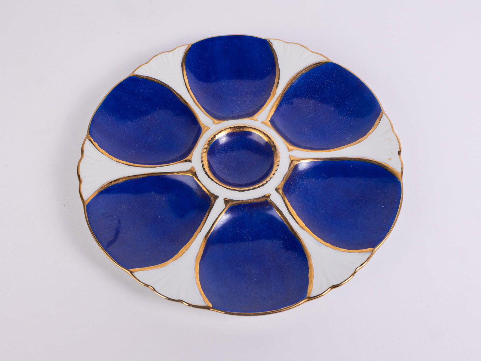 Antique Limoges Six Well Cobalt Blue Porcelain Oyster Plate: Antique Limoges Six Well Cobalt Blue Porcelain Oyster Plate, Oyster plate with six wells for oysters and one central well for sauce, decorated in cobalt and gold detailing. Signed H. Kline and marked
