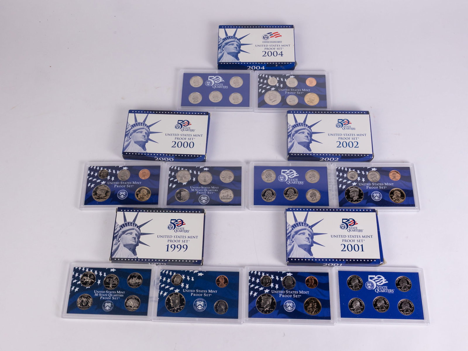 Five Proof Sets: (5) Proof Sets: 1999 9 Coin Proof Set - 2000 10 Coin Proof Set - 2001 10 Coin Proof Set - 2002 10 Coin Proof Set - 2004 11 Coin Proof SetLiteratureBrooks Auction – Online Auction Terms &