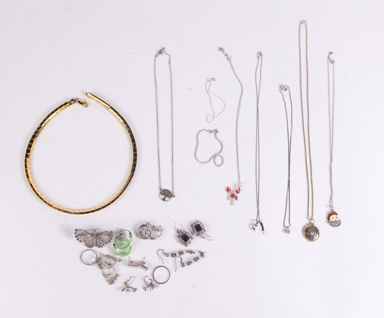 Sterling Silver Jewelry: Sterling Silver Jewelry: knotted ring, marked 925, size 5.5 - butterfly brooch, marked 800 - green hoop earrings, marked 925 - band, marked 925, size 7.75 - (2) bracelets, marked Italy 925 - Santa