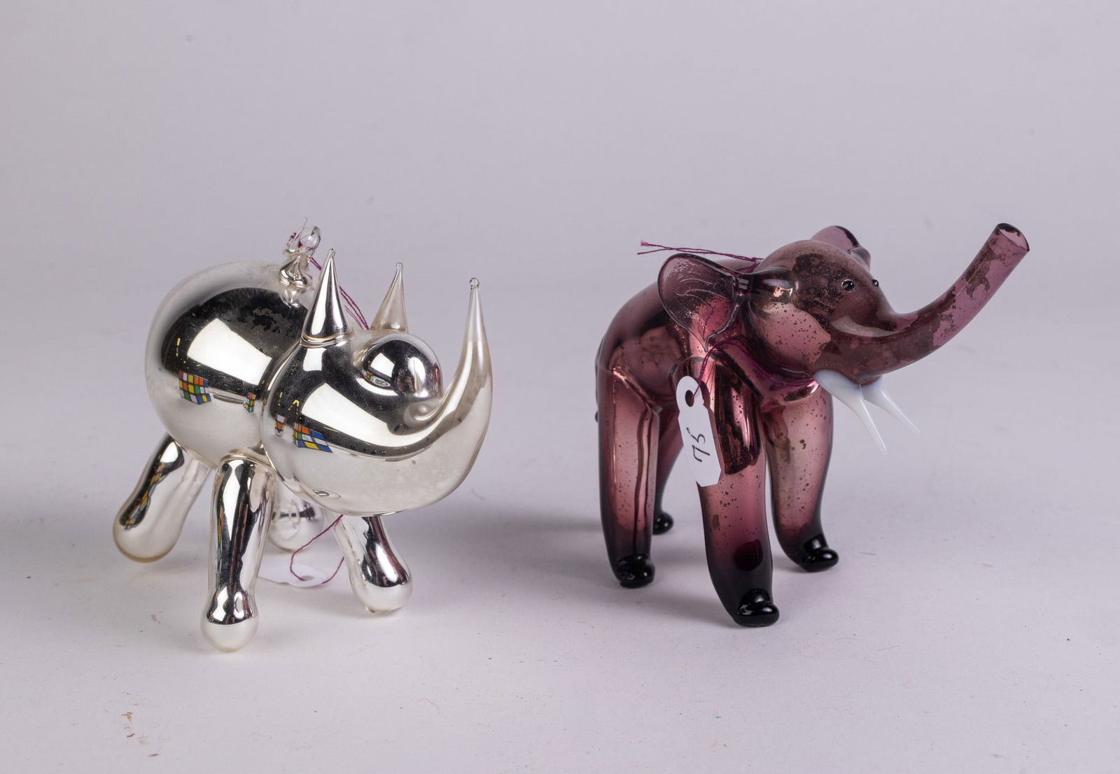 Two Mercury Glass German Animal Figure Ornaments: Two Mercury Glass German Animal Figure Ornaments, Two beautiful mercury glass ornaments in the form of a silver rhinoceros and a purple elephant. Literature Brooks Auction – Online Auction Terms