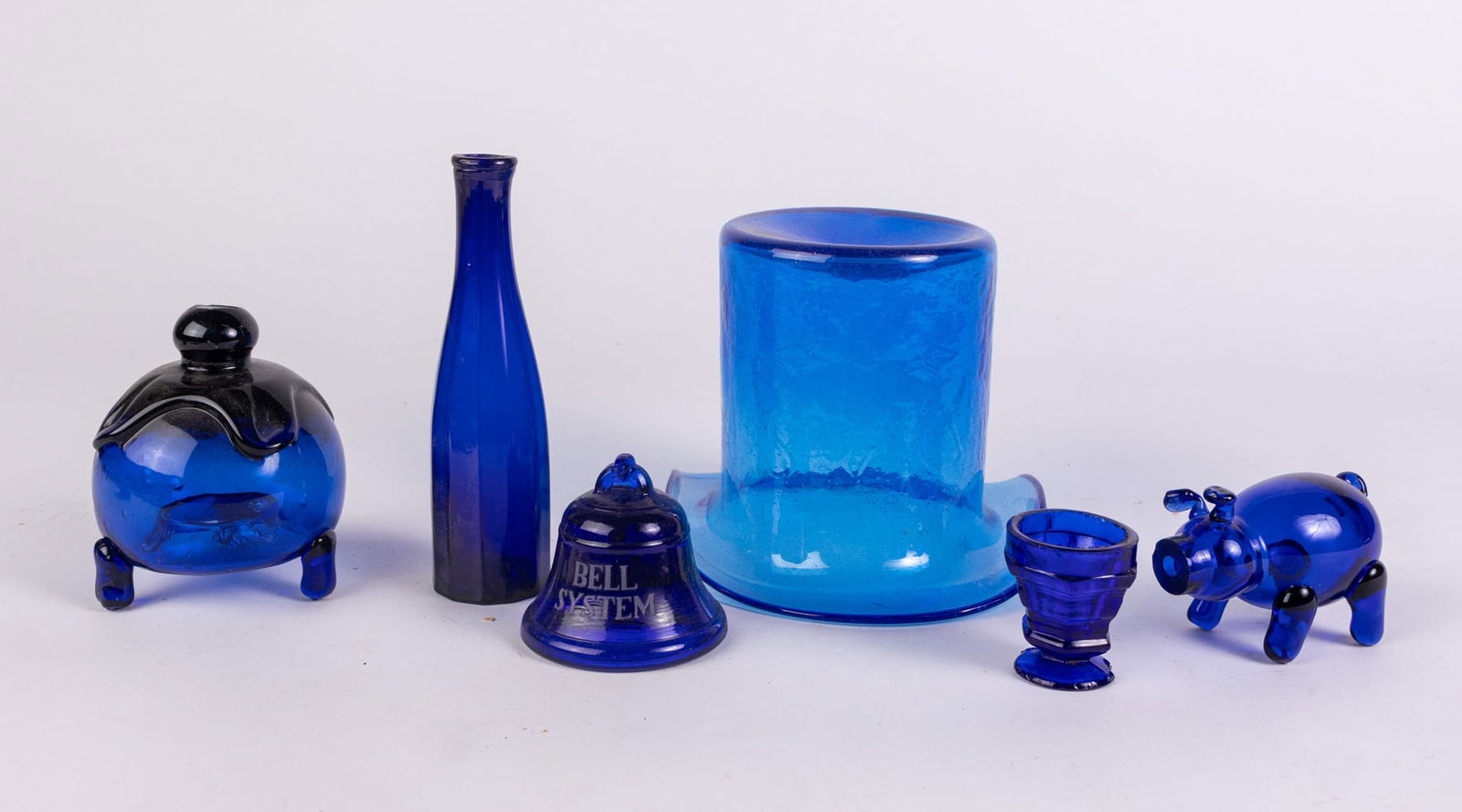 Grouping of Vintage & Antique Cobalt Glass & Whimsey Glass Articles: Grouping of Vintage & Antique Cobalt Glass & Whimsey Glass Articles Size 7" x 12" x 12" Literature Brooks Auction – Online Auction Terms & Conditions Contact: (856) 694-2960 | info@brooks.auct