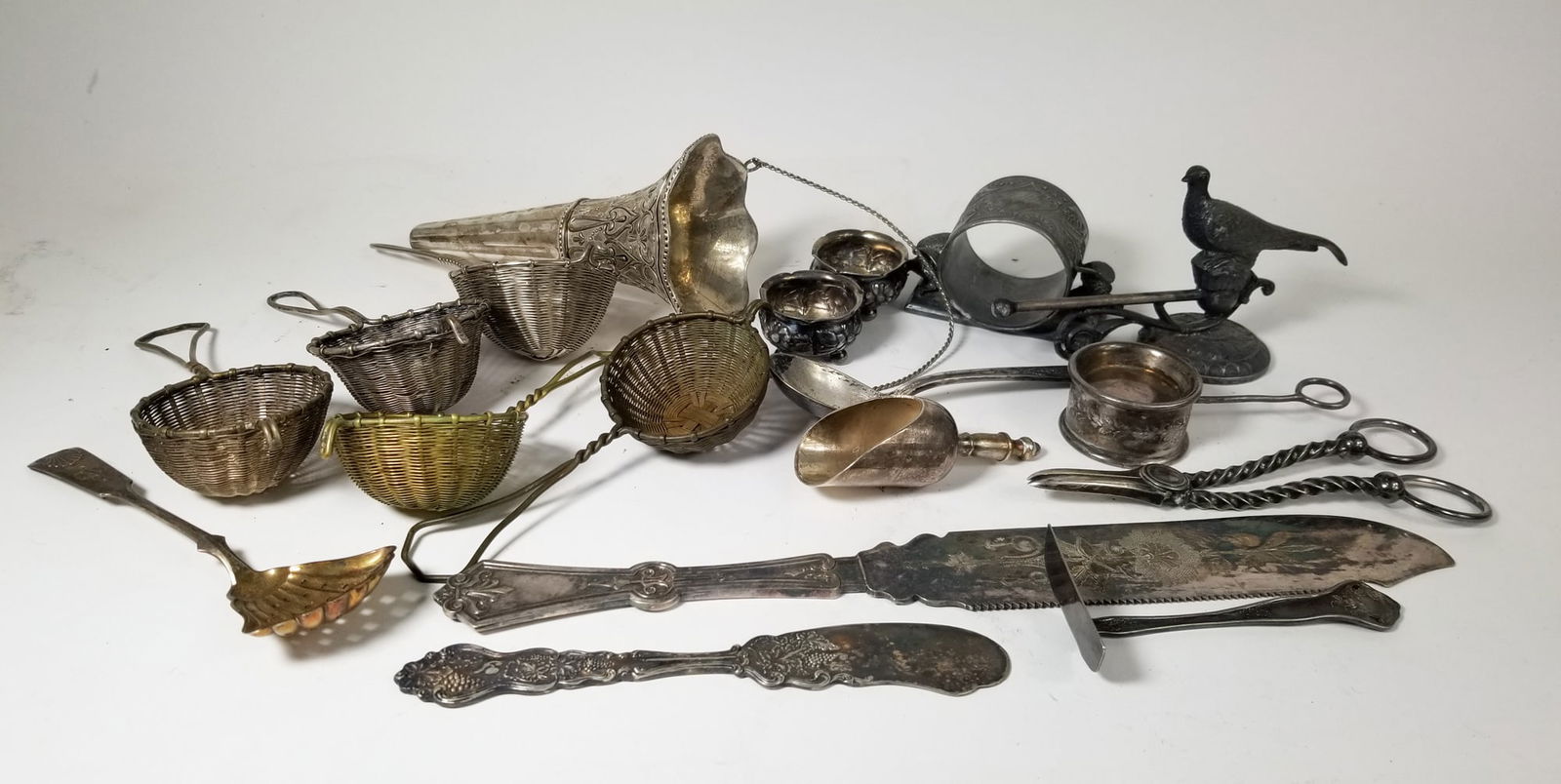 Assortment of Antique Silverplate Articles ft. Victorian Grape Scissors: Assortment of Antique Silverplate Articles ft. Victorian Grape ScissorsSize7" x 12" x 12"LiteratureBrooks Auction – Online Auction Terms & Conditions Contact: (856) 694-2960 |