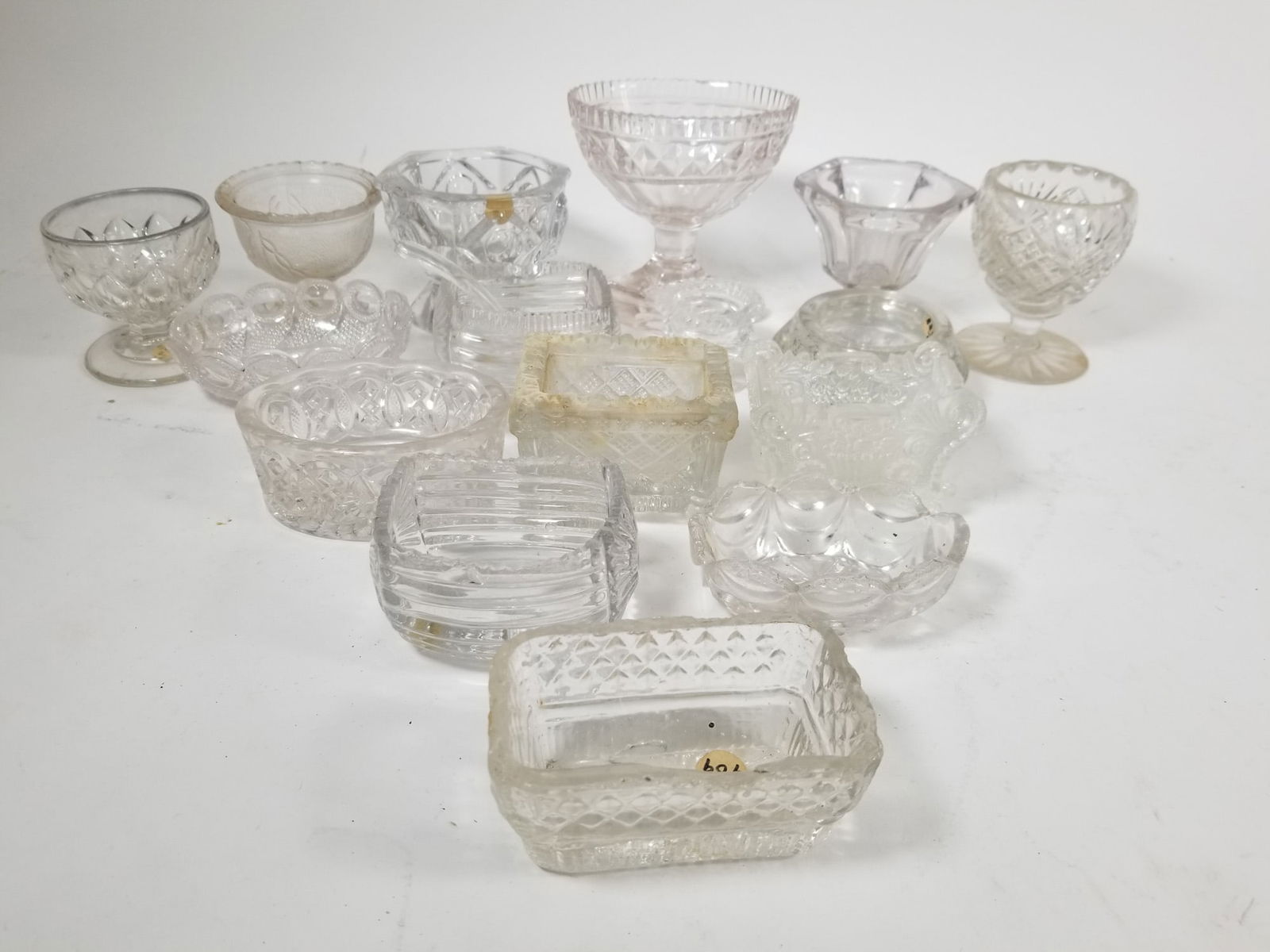 Assortment of Antique EAPG Open Salts: Assortment of Antique EAPG Open SaltsSize7" x 12" x 12"LiteratureBrooks Auction – Online Auction Terms & Conditions Contact: (856) 694-2960 | info@brooks.auction READ BEFORE YOU BID: We want