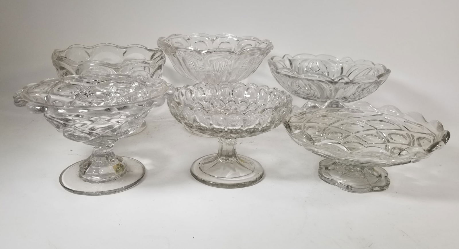 Grouping of Antique EAPG Compotes ft. Thumbprint Pattern: Grouping of Antique EAPG Compotes ft. Thumbprint PatternSize7" x 12" x 12"LiteratureBrooks Auction – Online Auction Terms & Conditions Contact: (856) 694-2960 | info@brooks.auction READ BEFORE