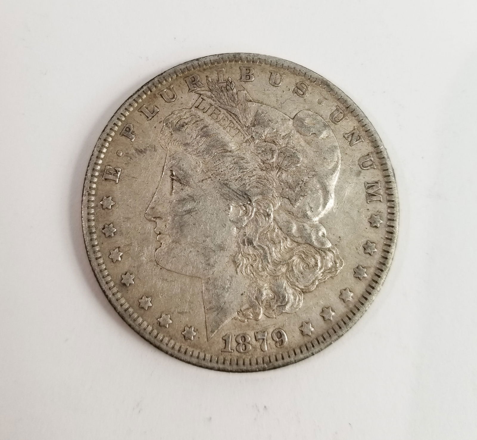 1879 Morgan Silver Dollar: 1879 Morgan Dollar *O* 90% SilverLiteratureBrooks Auction – Online Auction Terms & Conditions Contact: (856) 694-2960 | info@brooks.auction READ BEFORE YOU BID: We want you to feel confident