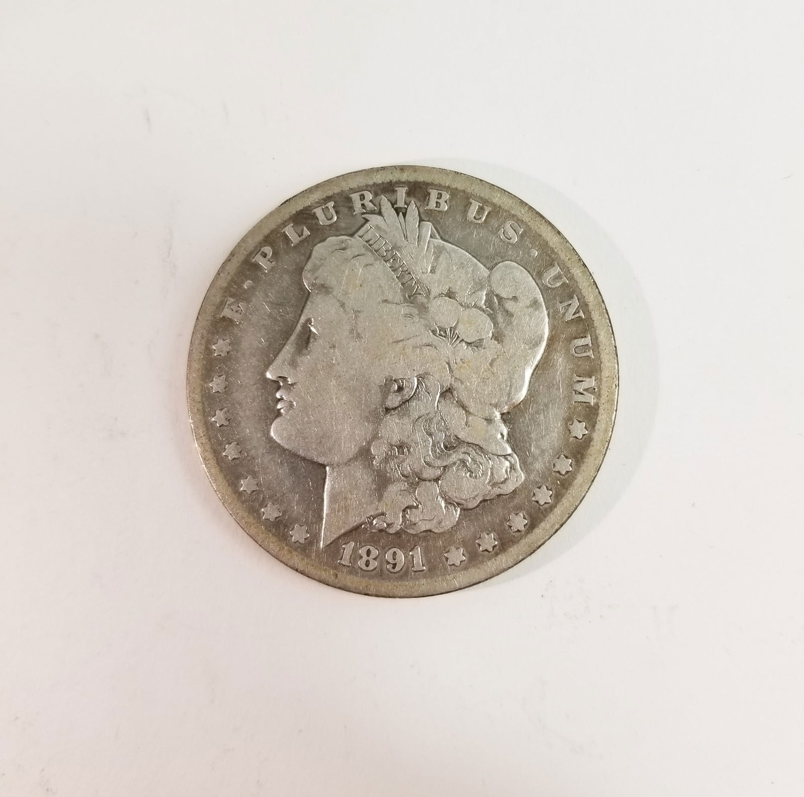 1891 Morgan Silver Dollar: 1891 Morgan Dollar *O* 90% Silver Literature Brooks Auction – Online Auction Terms & Conditions Contact: (856) 694-2960 | info@brooks.auction READ BEFORE YOU BID: We want you to feel confident w