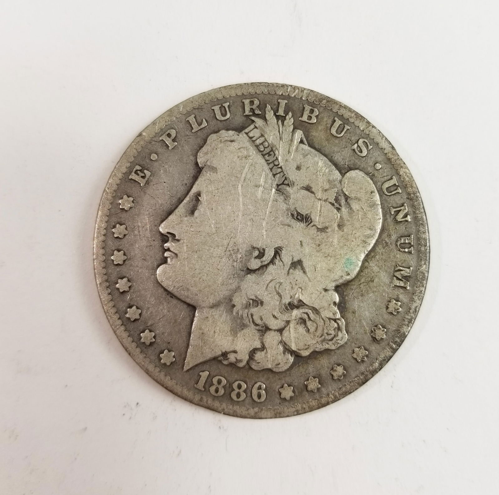 1886 Morgan Silver Dollar: 1886 Morgan Dollar *O* 90% Silver Literature Brooks Auction – Online Auction Terms & Conditions Contact: (856) 694-2960 | info@brooks.auction READ BEFORE YOU BID: We want you to feel confident w