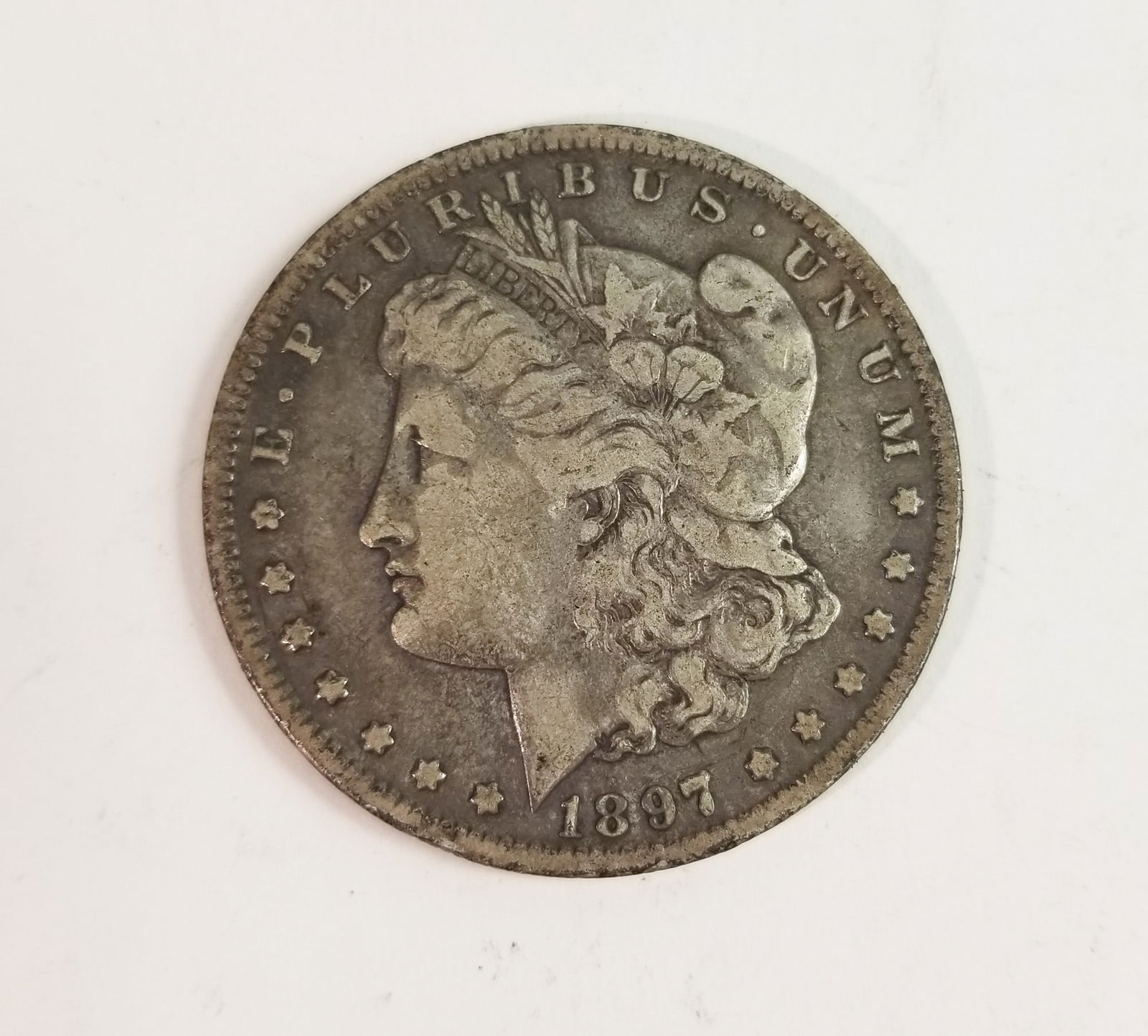 1897 Morgan Silver Dollar: 1897 Morgan Dollar *O* 90% Silver Literature Brooks Auction – Online Auction Terms & Conditions Contact: (856) 694-2960 | info@brooks.auction READ BEFORE YOU BID: We want you to feel confident w