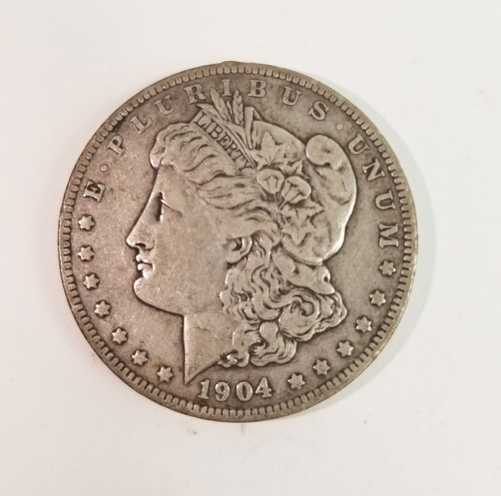 1904 Morgan Silver Dollar: 1904 Morgan Dollar *P* 90% SilverLiteratureBrooks Auction – Online Auction Terms & Conditions Contact: (856) 694-2960 | info@brooks.auction READ BEFORE YOU BID: We want you to feel confident