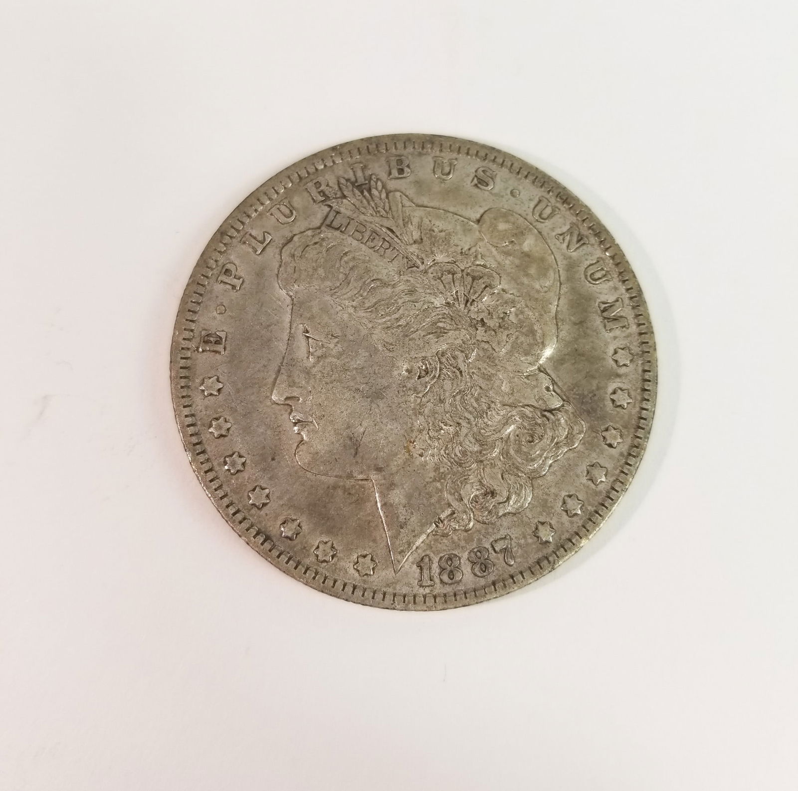 1887 Morgan Silver Dollar: 1887 Morgan Dollar *O* 90% SilverLiteratureBrooks Auction – Online Auction Terms & Conditions Contact: (856) 694-2960 | info@brooks.auction READ BEFORE YOU BID: We want you to feel confident
