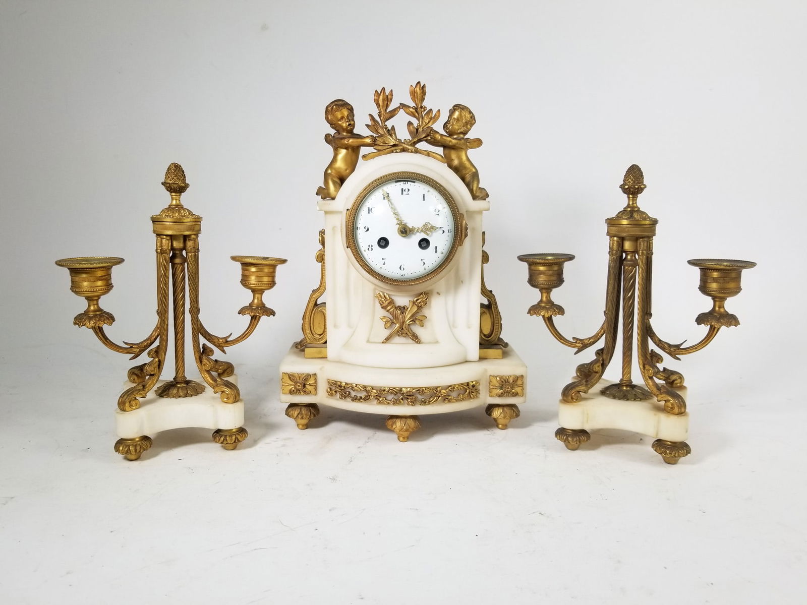 Antique Marble and Brass French Style Mantel Set: Antique Marble and Brass French Style Mantel Set: Live your Marie Antoinette rococo fantasy with this beautiful ornate three piece mantel set including clock with porcelain face, cherub adornments, as