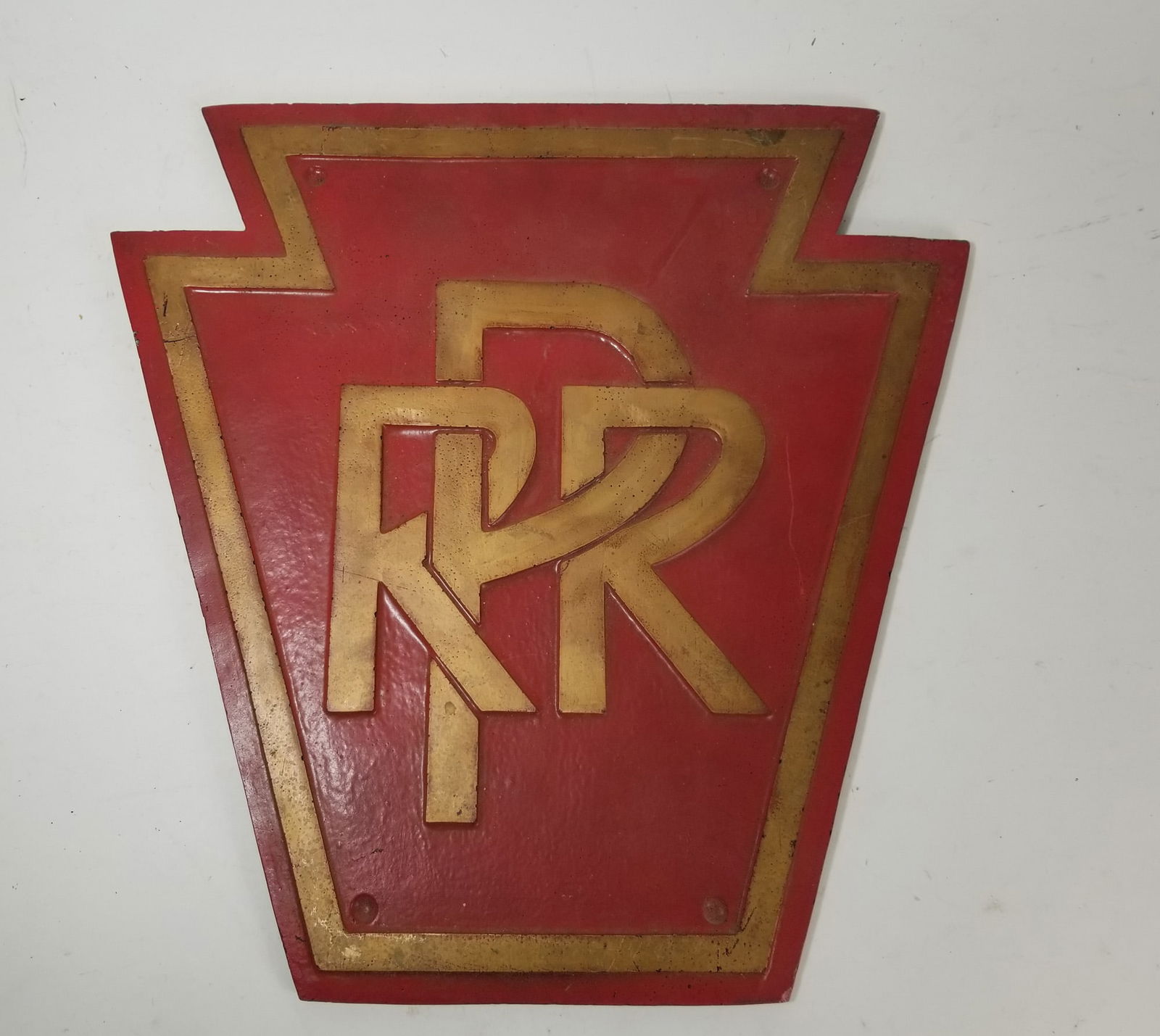 Vintage Pennsylvania Railroad Wall Mounted Sign: Vintage Pennsylvania Railroad Wall Mounted Sign, This 17" sign features the classic PRR keystone logo in gold and dark red. On the back, it includes a keystone shaped note with a funky little