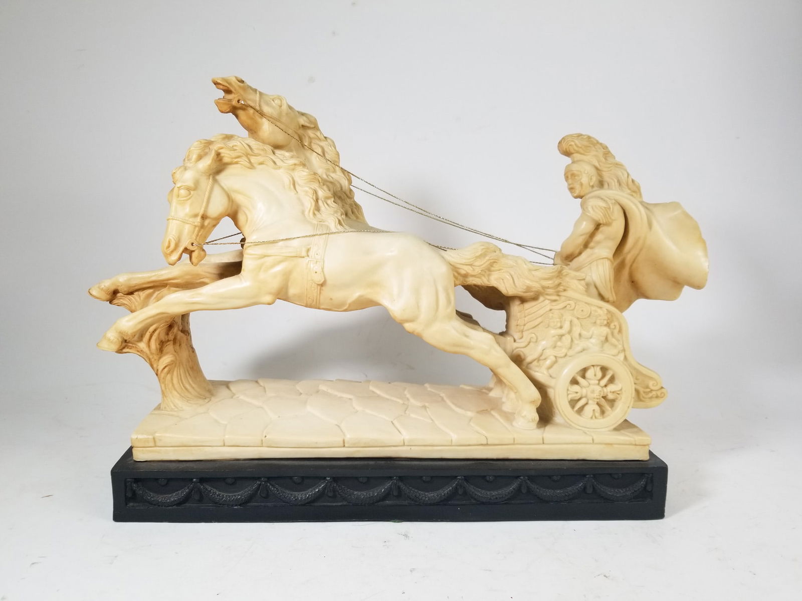 Vintage Roman Chariot Sculpture made of Heavy Resin: Vintage Roman Chariot Sculpture made of Heavy ResinSize13" x 16" x 6"LiteratureBrooks Auction – Online Auction Terms & Conditions Contact: (856) 694-2960 | info@brooks.auction READ BEFORE YOU