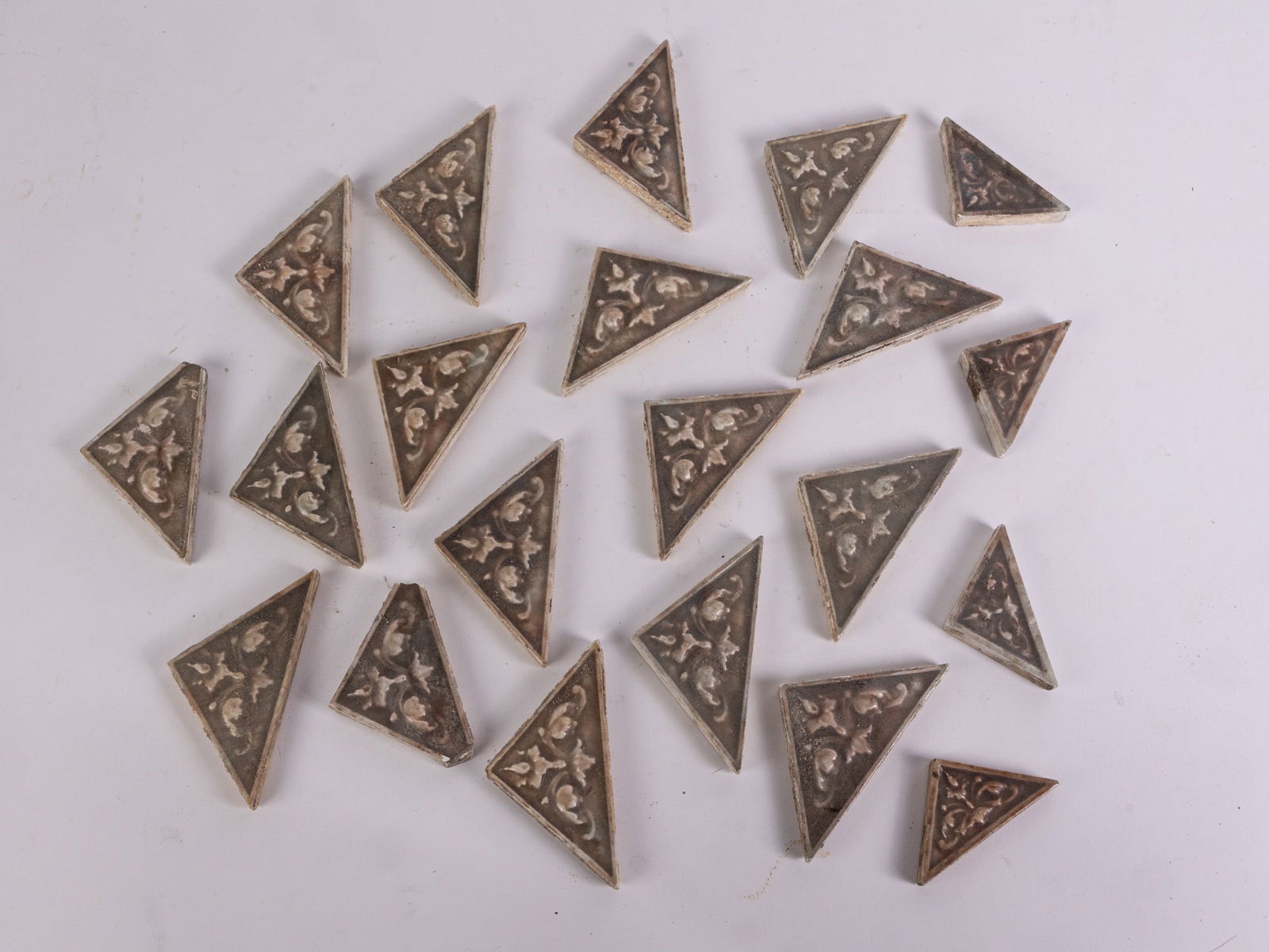 Twenty One Vintage Architectural Salvage Triangular Ceramic Tiles: Twenty One Vintage Architectural Salvage Triangular Ceramic Tiles, eighteen of the tiles are 4" x 2", three of the tiles are 1.5" x 2.5"Size4" x 2"LiteratureBrooks Auction – Online Auction
